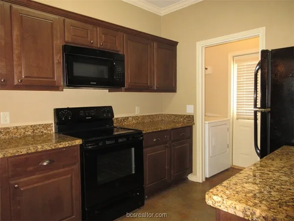 a kitchen with a refrigerator stove and cabinets