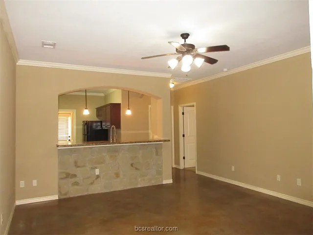 a view of a hallway with a chandelier fan and wooden floor