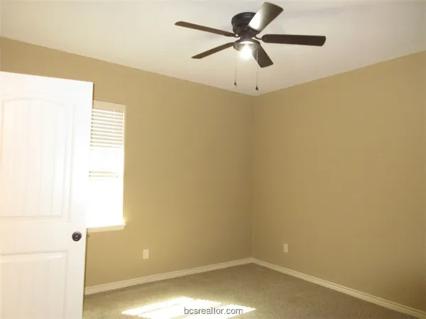 a view of a small space with wooden floor and a window