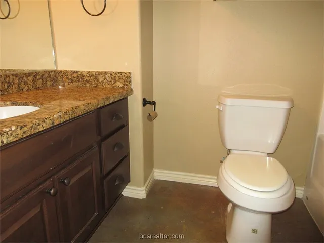 a bathroom with a toilet and a sink