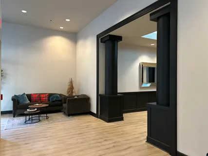 a living room with furniture and a wooden floor