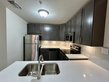 a kitchen with stainless steel appliances a refrigerator and a sink