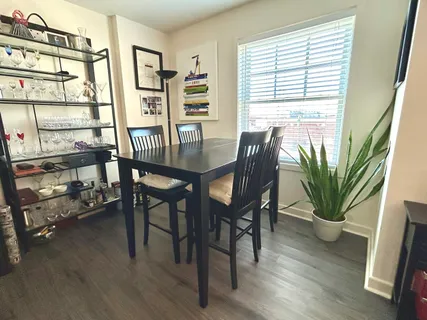 a dining room with furniture and wooden floor