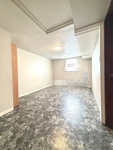 a view of a big room with wooden floor and windows