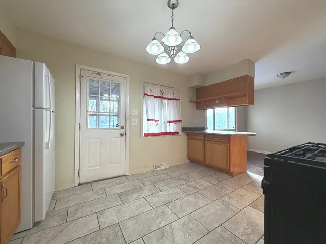 a kitchen with stainless steel appliances granite countertop a refrigerator and a stove top oven