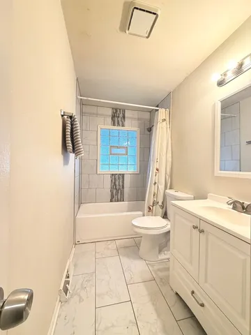 a bathroom with a sink a toilet and tub