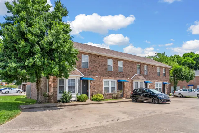 a car parked in front of a brick building