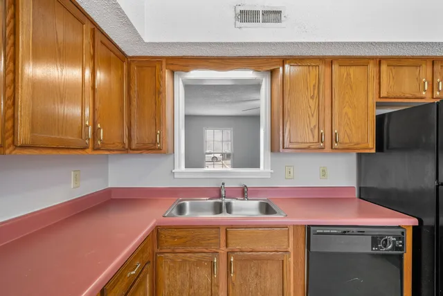 a utility room with cabinets washer and dryer