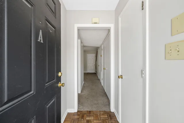 a view of a hallway view with wooden floor and staircase