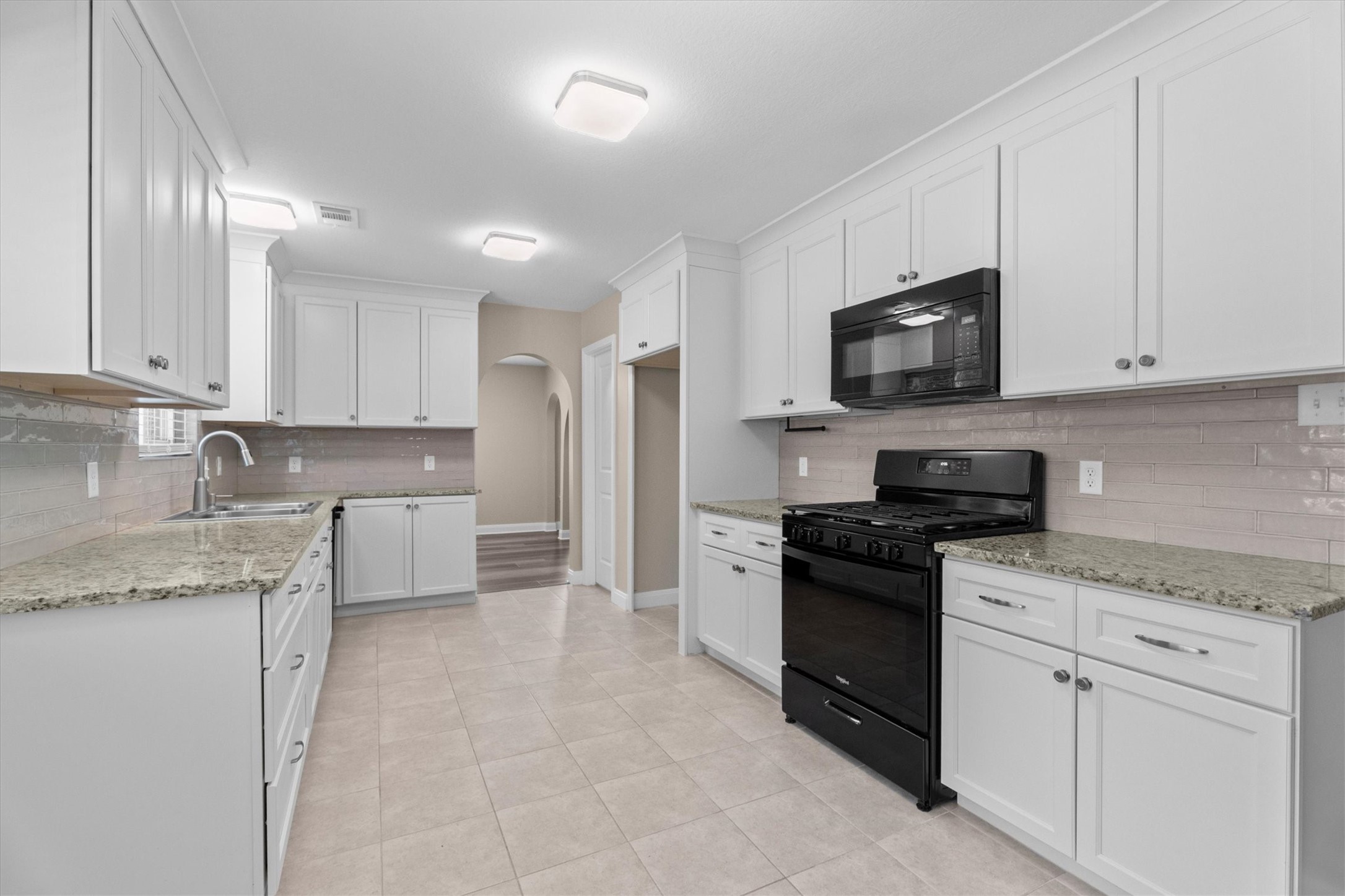 6530 Bayonne Drive Spring, TX 77389 - Photo 16 of 37 a kitchen with stainless steel appliances granite countertop a stove a sink and a granite counter tops