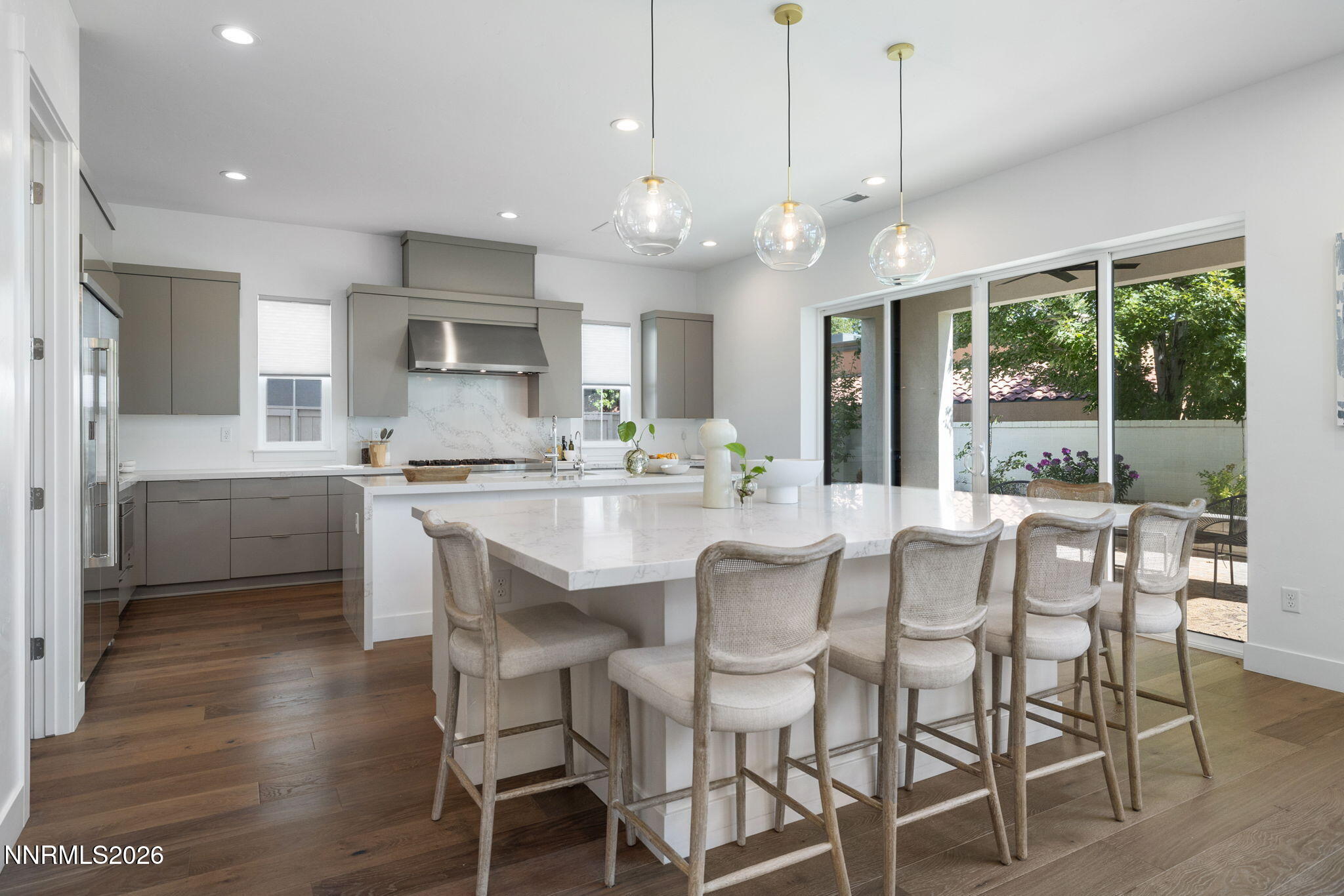 5406 Side Saddle Trail Reno, NV 89511 - Photo 4 of 39 a dining room with stainless steel appliances kitchen island granite countertop a dining table chairs and granite counter tops
