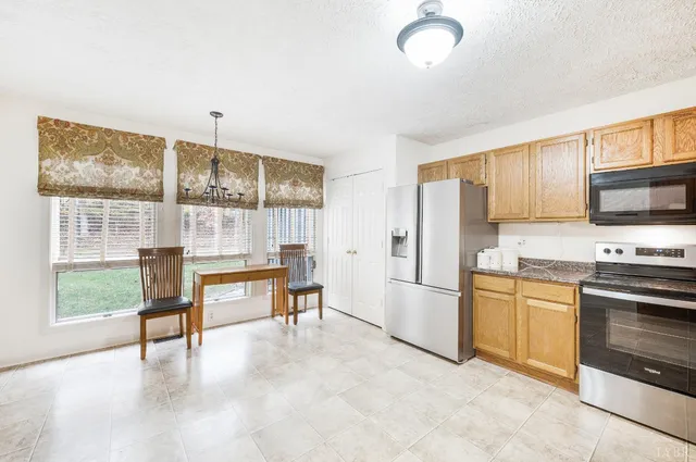 a kitchen with stainless steel appliances granite countertop a stove and a refrigerator
