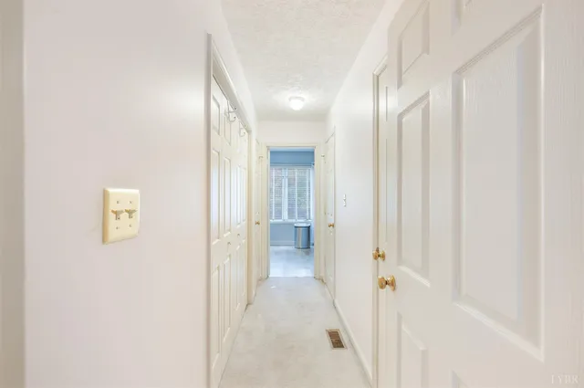 a view of a hallway with wooden shelves