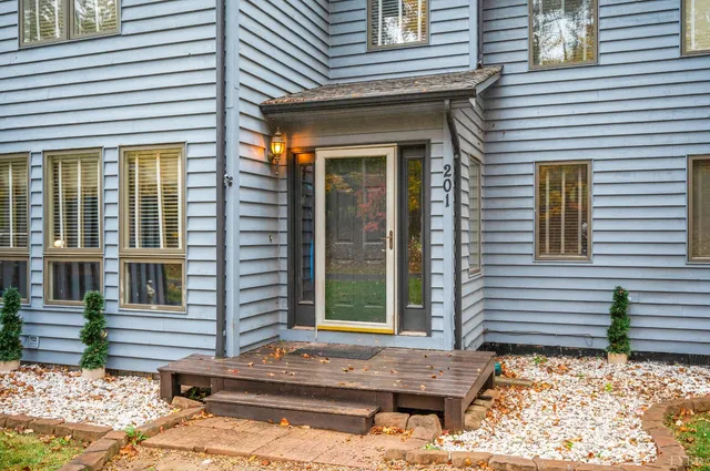a view of a house with door and wooden fence
