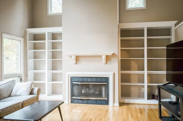 a living room with a furniture and a fireplace