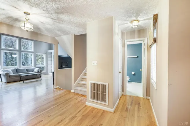 a view of a livingroom with furniture wooden floor and windows
