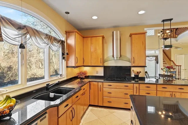 a kitchen with granite countertop a sink and cabinets