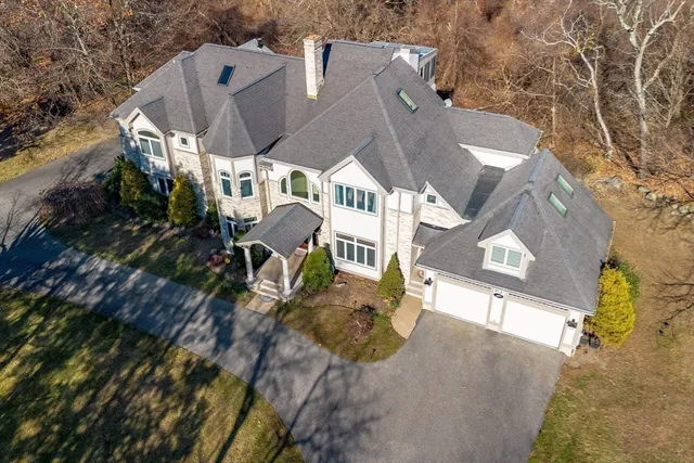 an aerial view of a house with a yard
