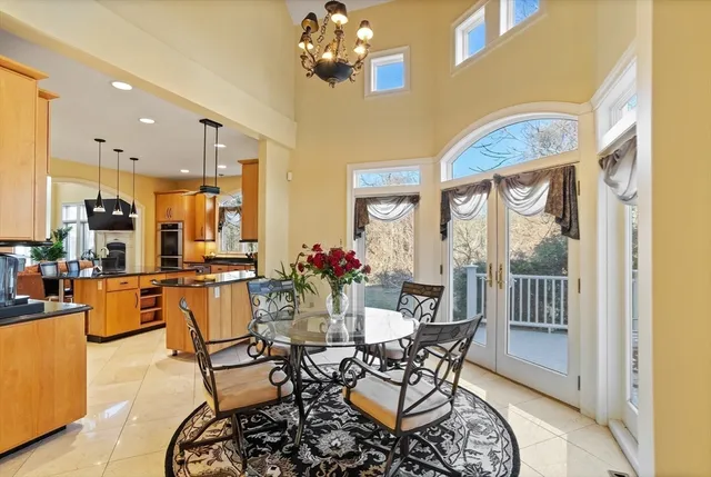 a dining room with furniture a chandelier and wooden floor