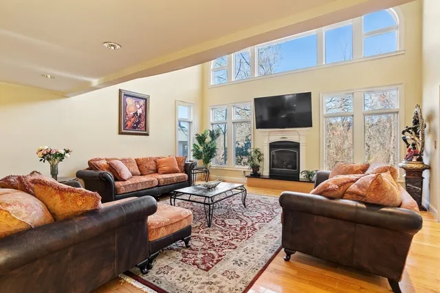 a living room with furniture a flat screen tv and a fireplace
