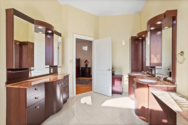 a spacious bathroom with a bathtub sink and mirror