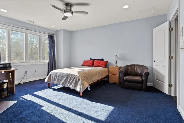 a bedroom with a bed couch and a window