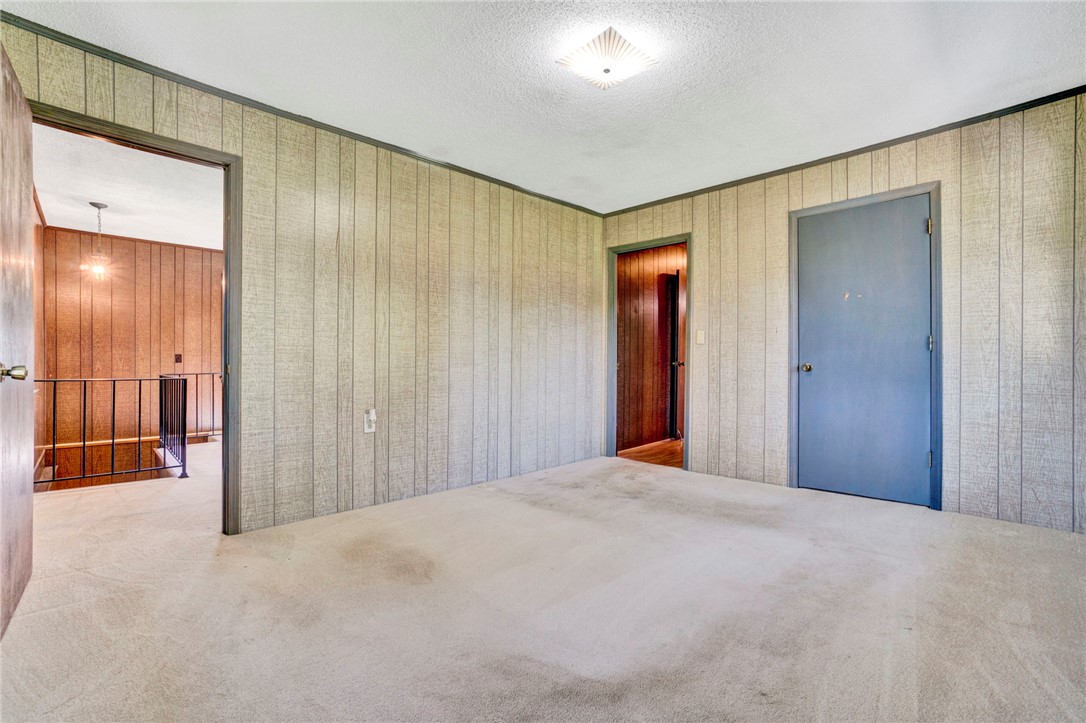 7876 Highway 11 Walhalla, SC 29691 - Photo 27 of 35 A versatile room featuring textured wall panels and a soft carpet, ready for personalization.