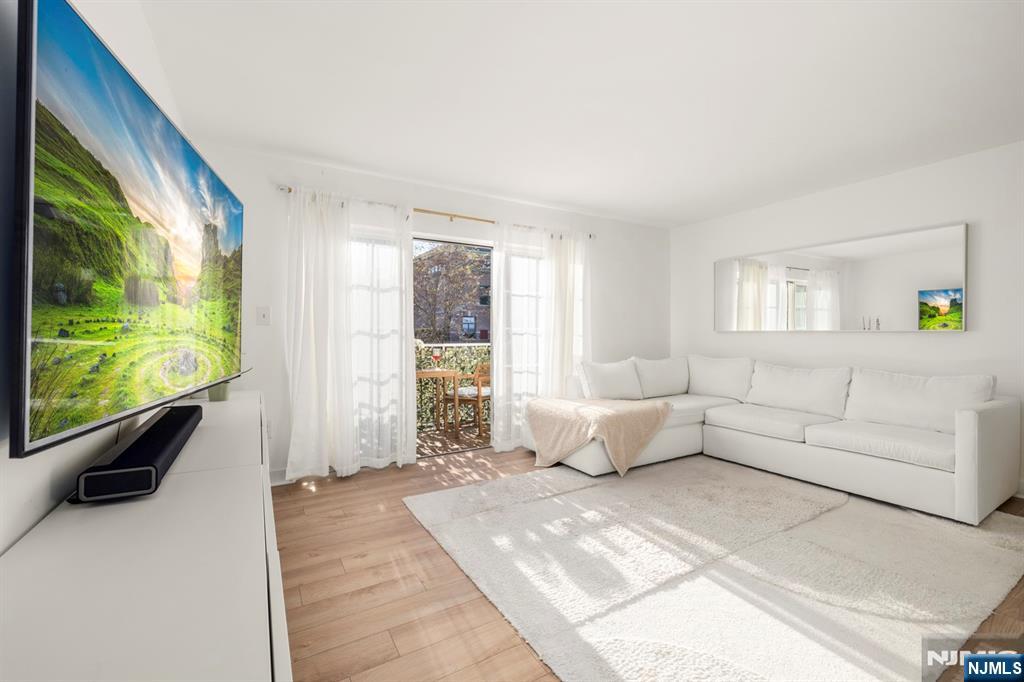 100 Crown Court, Unit 482 Edgewater, NJ 07020 - Photo 3 of 16 a living room with furniture and a flat screen tv