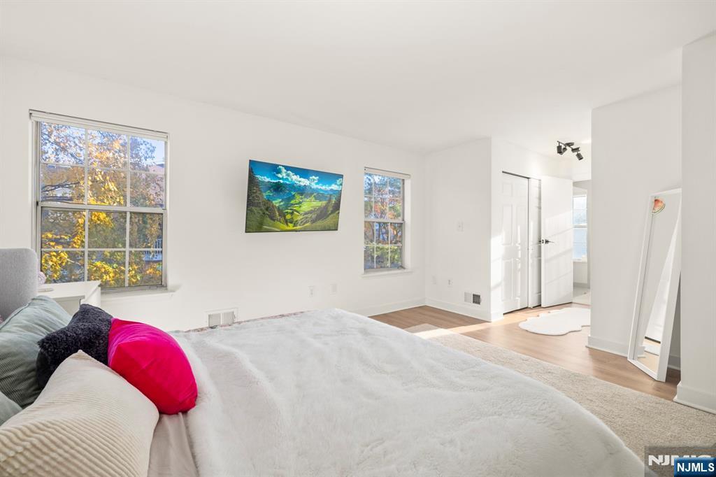 100 Crown Court, Unit 482 Edgewater, NJ 07020 - Photo 9 of 16 a bedroom with a bed and a window