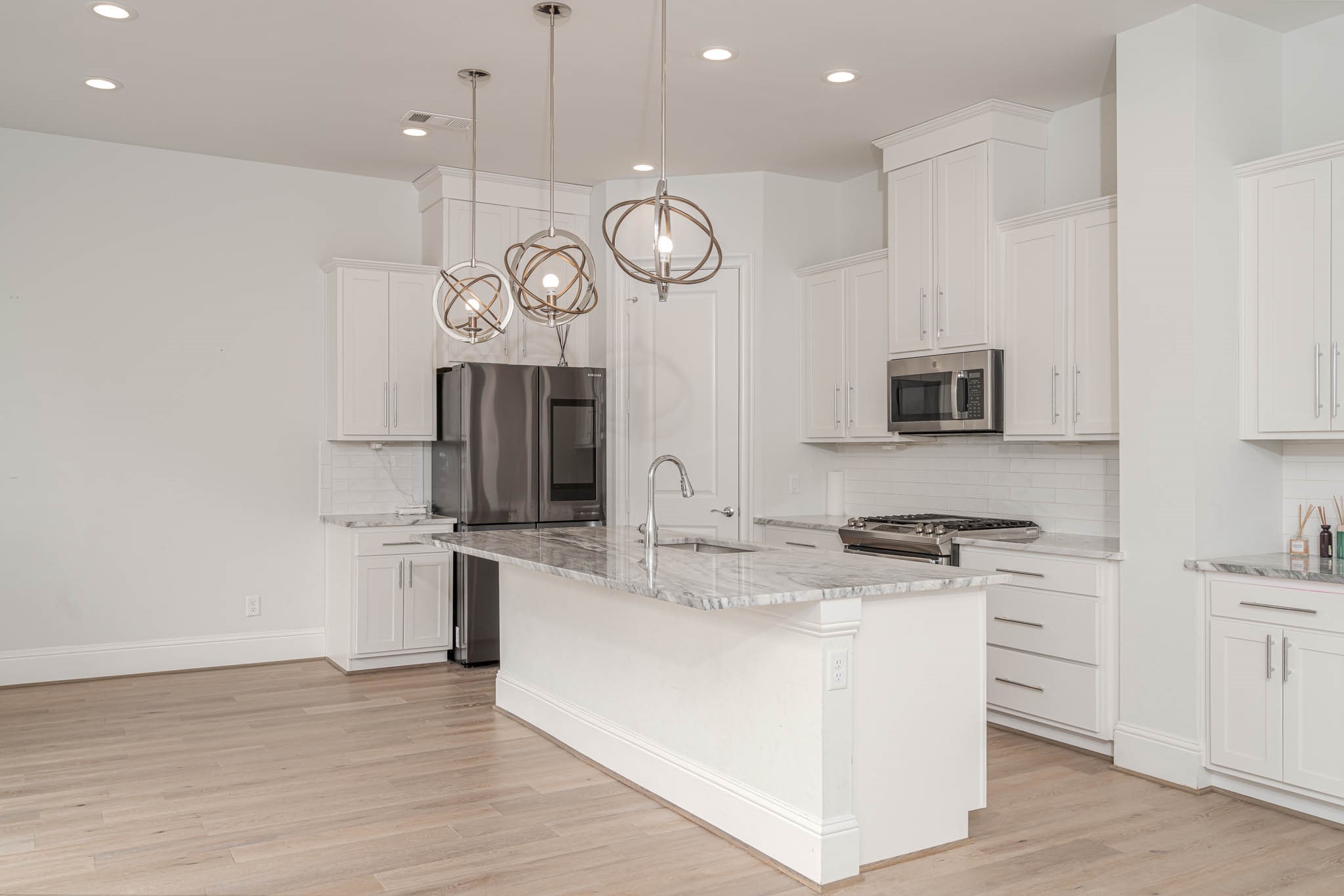 7715 South Fall Run Crossing Houston, TX 77055 - Photo 7 of 22 a kitchen with stainless steel appliances granite countertop a stove a sink and a microwave