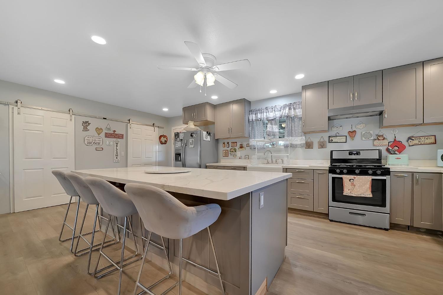 3585 South Burson Road Valley Springs, CA 95252 - Photo 2 of 99 a kitchen with stainless steel appliances kitchen island granite countertop a sink a stove a dining table and chairs
