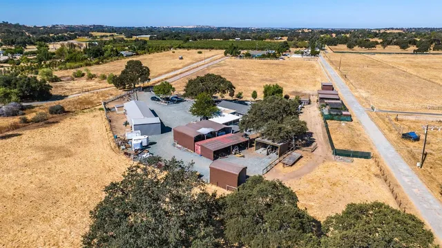 an aerial view of a house with a yard and garden
