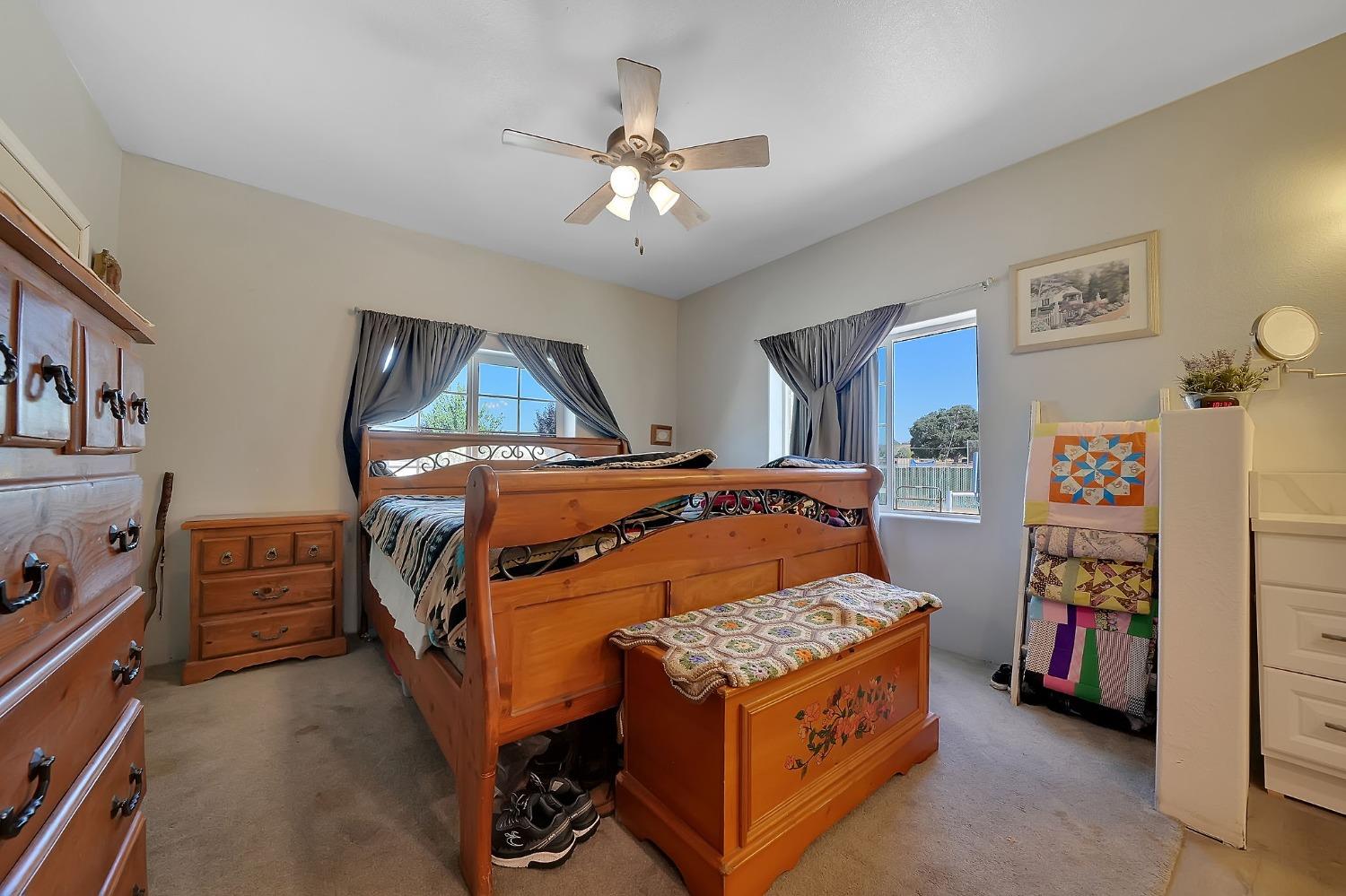 3585 South Burson Road Valley Springs, CA 95252 - Photo 67 of 99 a bedroom with a bed and a chandelier