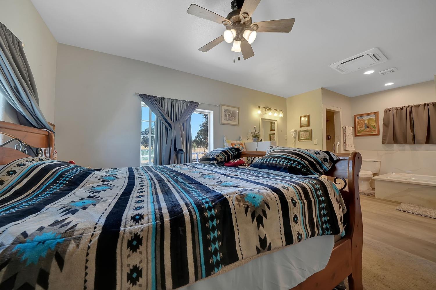 3585 South Burson Road Valley Springs, CA 95252 - Photo 68 of 99 a bed room with a bed and a chandelier