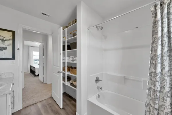 a bathroom with a bathtub and a shower