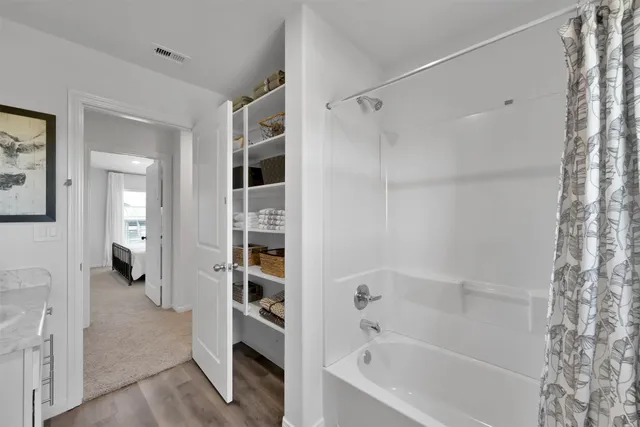 a bathroom with a bathtub and a shower