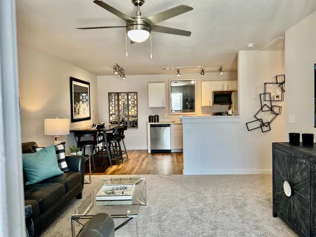 a living room with furniture and kitchen view