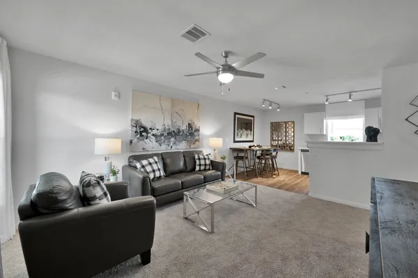 a living room with furniture and kitchen view
