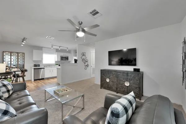 a living room with furniture and a flat screen tv