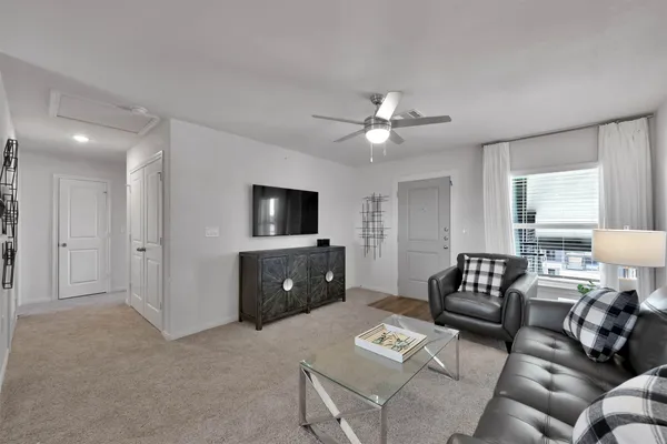 a living room with furniture and a flat screen tv