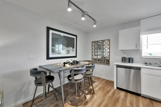a view of a dining room with furniture and wooden floor