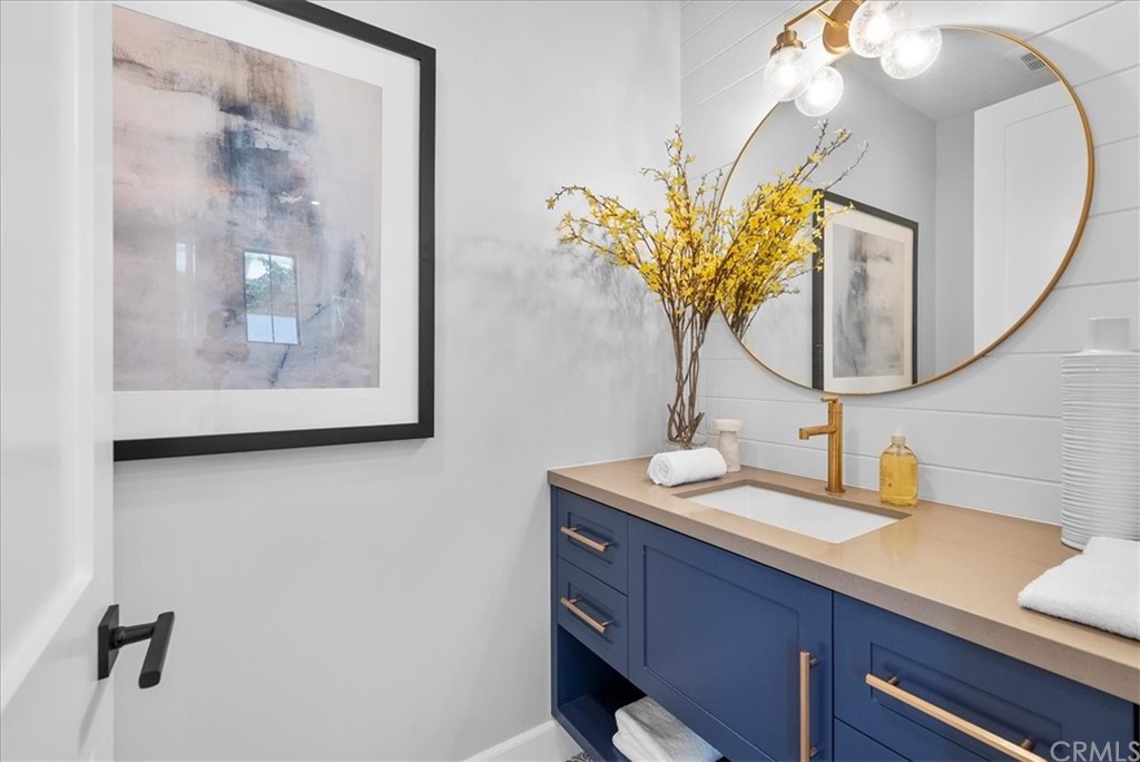 615 23rd Street Manhattan Beach, CA 90266 - Photo 14 of 36 a bathroom with a sink a mirror and a potted plant