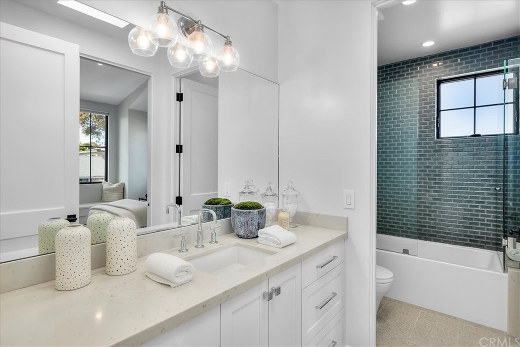 615 23rd Street Manhattan Beach, CA 90266 - Photo 17 of 36 a bathroom with a granite countertop sink and a large mirror