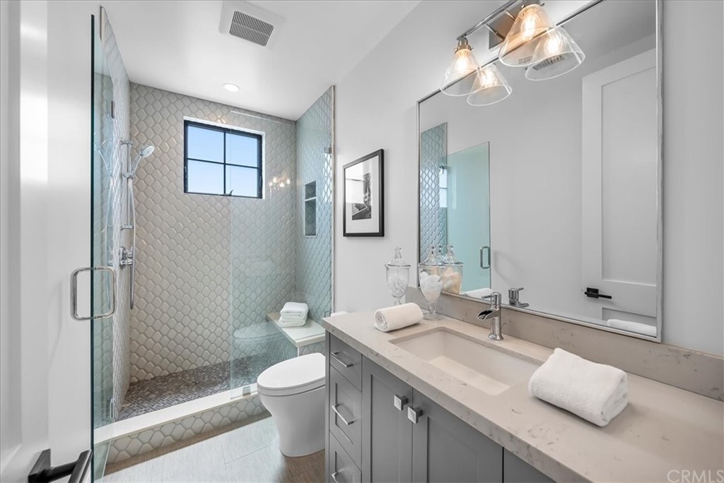 615 23rd Street Manhattan Beach, CA 90266 - Photo 19 of 36 a bathroom with a granite countertop sink a toilet and shower