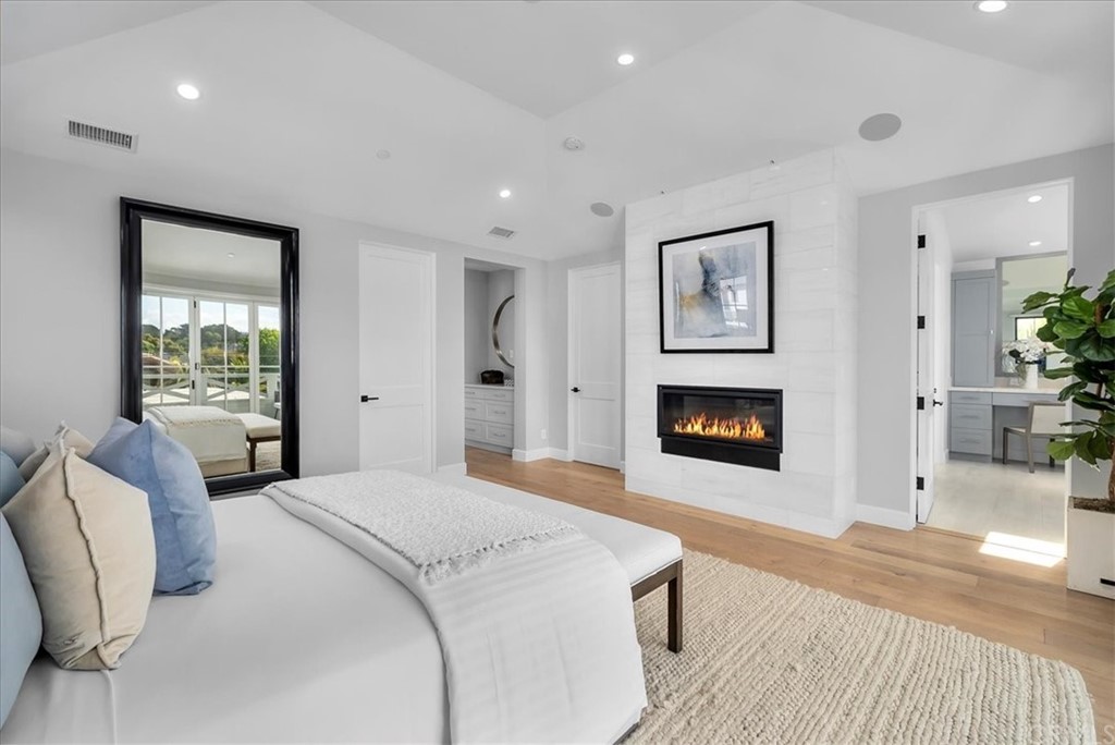615 23rd Street Manhattan Beach, CA 90266 - Photo 22 of 36 a spacious bedroom with a large bed and a fireplace