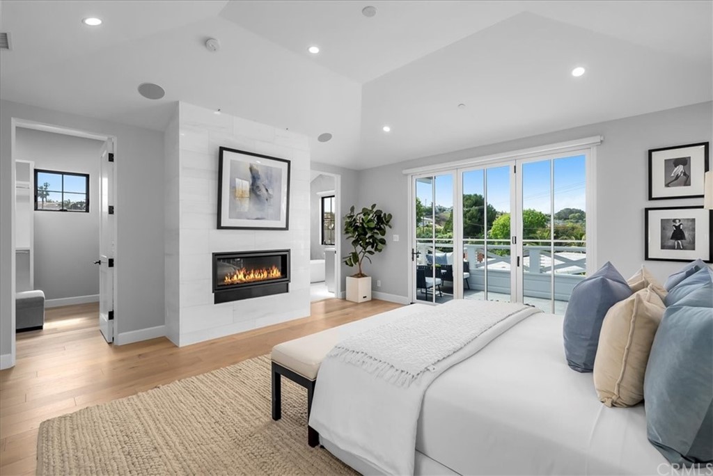 615 23rd Street Manhattan Beach, CA 90266 - Photo 23 of 36 a spacious bedroom with a large bed and a fireplace