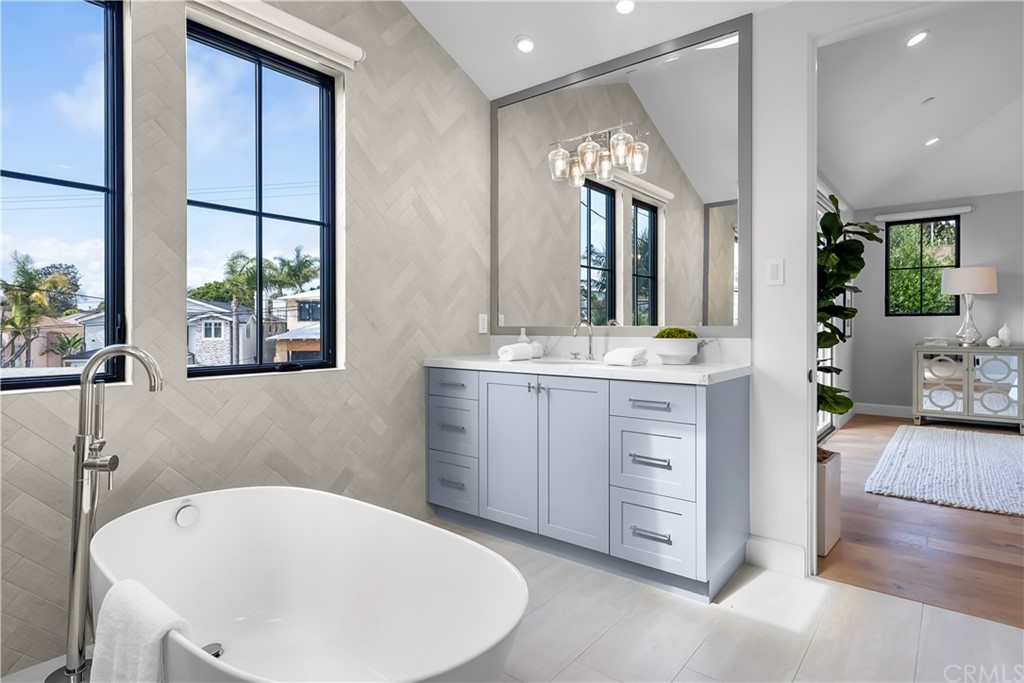 615 23rd Street Manhattan Beach, CA 90266 - Photo 25 of 36 a spacious bathroom with a tub sink and mirror