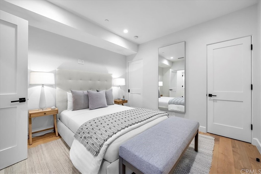 615 23rd Street Manhattan Beach, CA 90266 - Photo 32 of 36 a bedroom with a bed and wooden floor