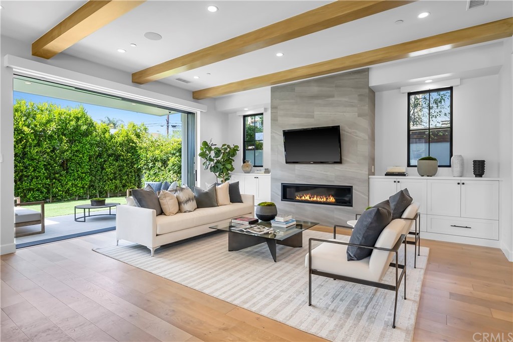 615 23rd Street Manhattan Beach, CA 90266 - Photo 10 of 36 a living room with furniture a fireplace and a large window