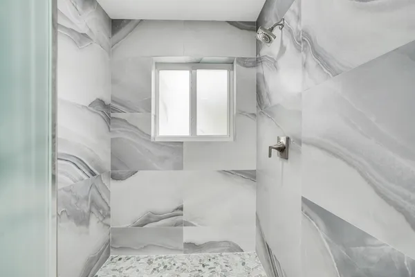 a bathroom with a bathtub and shower